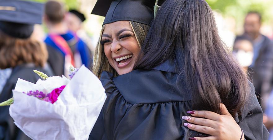 Two friends hug after SPU